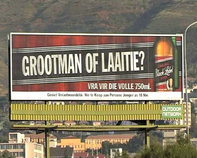 The picture above is one example of South African alcohol advertising. "Are you a big man or a small boy", asks the huge billboard from Carlings, promoting big 750 ml bottles of their beer Black Label.