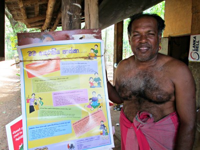 Men engage village member with Loving father poster - 400p.jpg