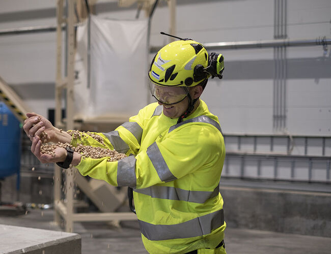 Fabrikksjef Ole Frantzen med den hvite trepelletsen som produseres på fabrikken på Sokna. Foto: Moelven