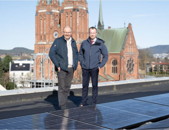 Fra høyre, fylkesordfører Sven Tore Løkslid og fylkesvaraordfører Terje Riis-Johansen inspiserer solcellene som har kommet på plass på taket av Telemarkshuset i Skien. Foto: Tom Holen