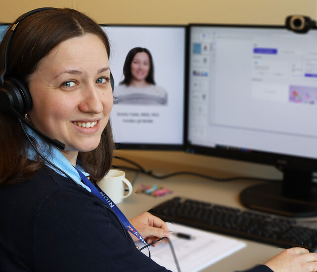 Picture showing NIOM researcher Amela Tulek at her desk in from of her computer screen.