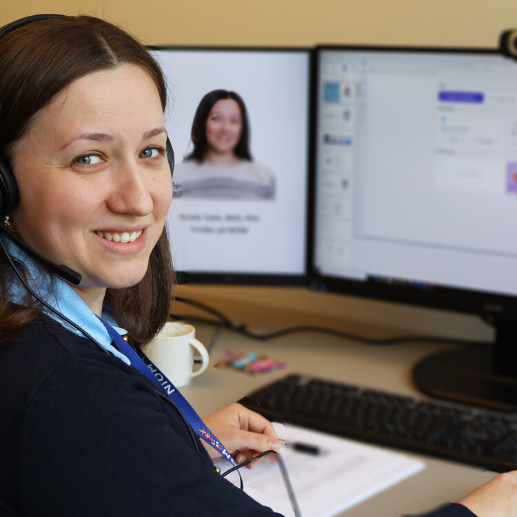 Picture showing NIOM researcher Amela Tulek at her desk in from of her computer screen.