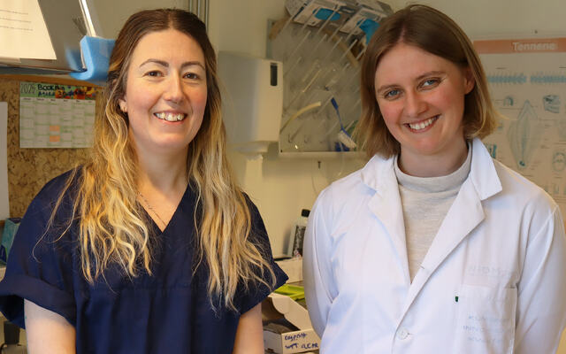 Picture of NIOM employee Heidi Holm and visiting scientist Kristine Andreassen standing in a NIOM lab.